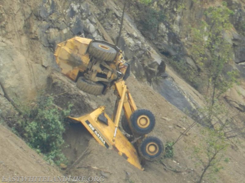 Photo taken with telephoto lens of quarry dump truck upside down on unsettled ground at Glasgow Quarry.